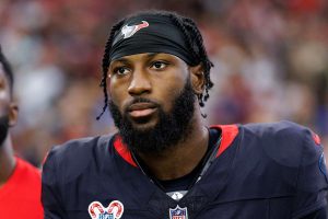kris boyd houston texans Professional American football player standing on the sideline during a game, wearing a black jersey and headband with a team logo.