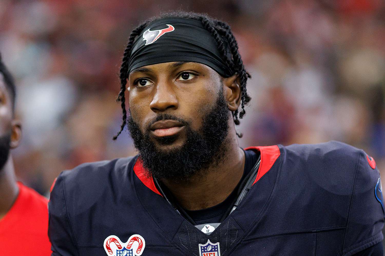 kris boyd houston texans Professional American football player standing on the sideline during a game, wearing a black jersey and headband with a team logo.