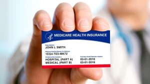 Medicare Part B card and Social Security card placed together on a desk, representing premium changes and federal benefits law.
