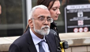 Subramanyam “Subu” Vedam, a Pennsylvania man wrongfully imprisoned for over 40 years, is escorted by officers outside a courthouse after his release and before being taken into ICE custody.