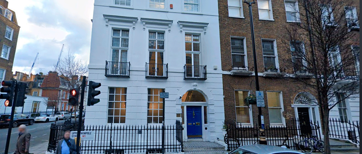 Exterior of the ARGC fertility clinic on Upper Wimpole Street in London, showing the white fa&ccedil;ade, blue front door, and surrounding street.