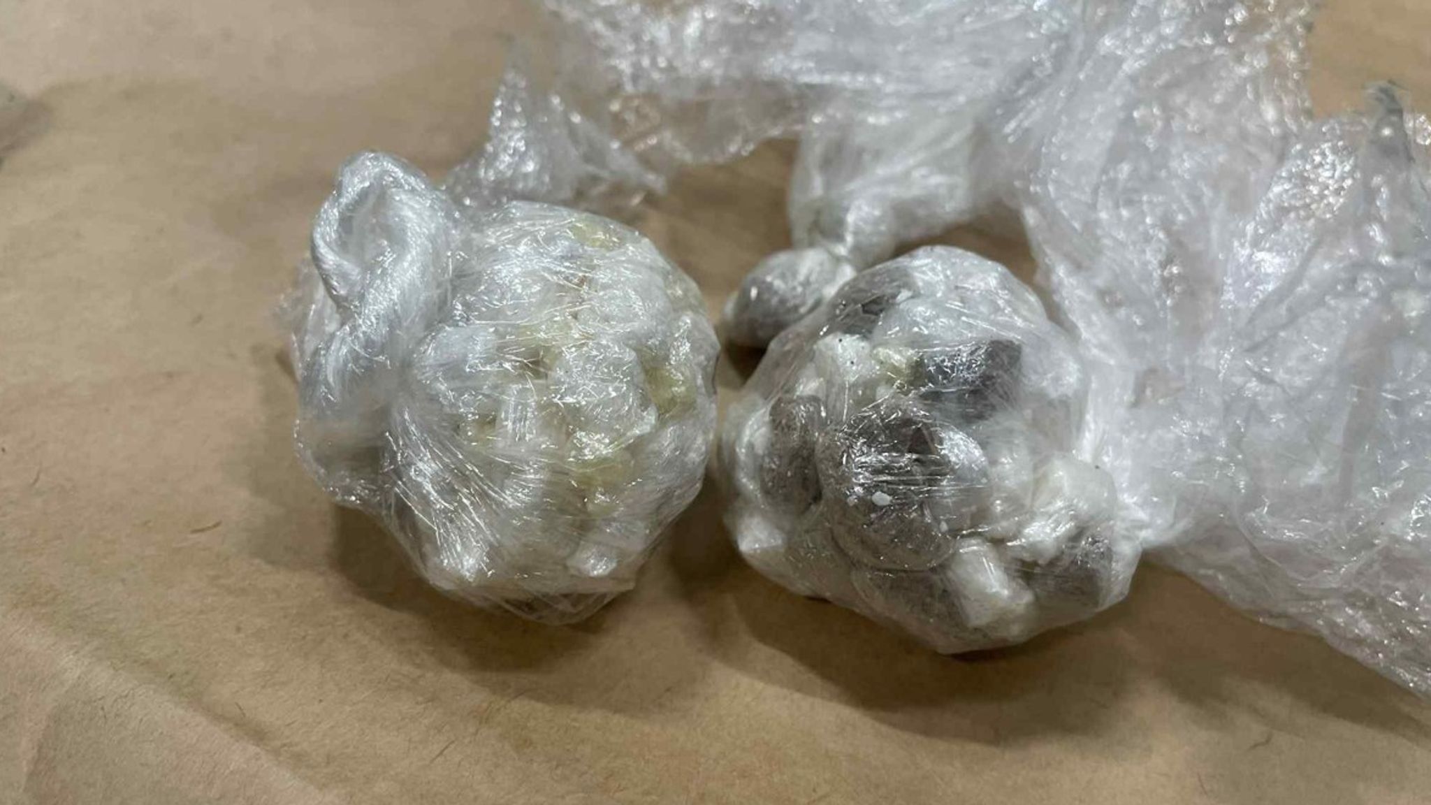 Bundles of suspected Class A drugs wrapped in clear plastic.