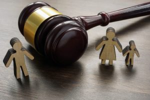 divorce and alimony concept. divided family figurines and a gavel.