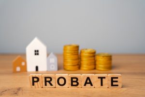 real estate that is part of a deceased person's estate and managed or distributed through the probate process. wooden blocks probate and miniature houses.