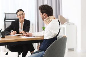 injured man signing document in lawyer's office, selective focus