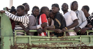 A group of migrants traveling in a crowded truck during a journey to seek asylum in Europe.