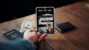 A symbolic press badge displayed on a desk with travel documents and currency — representing the global nature of investigative journalism and its role in legal accountability.