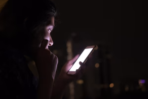 Teen Using Smartphone in Low Light