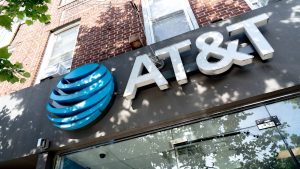 Exterior AT&T store signage with the company’s blue globe logo on a brick building.