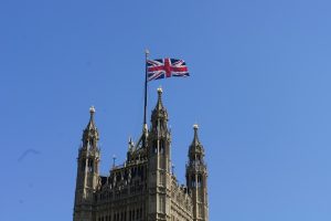 Union Jack flag flying above the Houses of Parliament in Westminster, London.