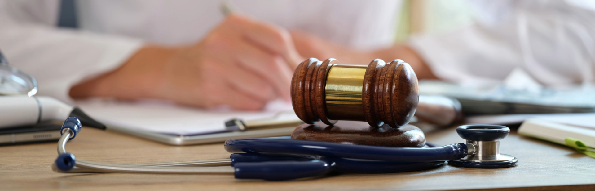 Courtroom gavel beside a medical device, symbolizing legal regulation of medical practice