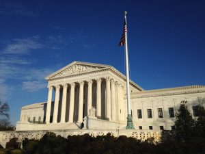 UK and US supreme court buildings symbolising high-stakes legal decisions and risk facing senior lawyers