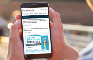 Person scrolling past sponsored ads on a smartphone, illustrating exposure to online scam advertising