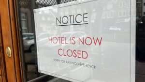 Closed hotel during lockdown with insurance paperwork visible inside